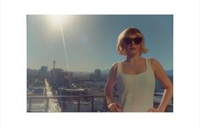 Image of Gwenno in the sunshine amongst city buildings